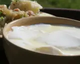 Gęste, domowe zsiadłe mleko w glinianej miseczce, obok ziemniaków z koperkiem. Prosty sposób, jak zrobić zsiadłe mleko.