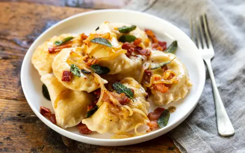Pyszne pierogi z boczkiem i cebulką. Dowiedz się, ile gotować pierogi, by były idealne.