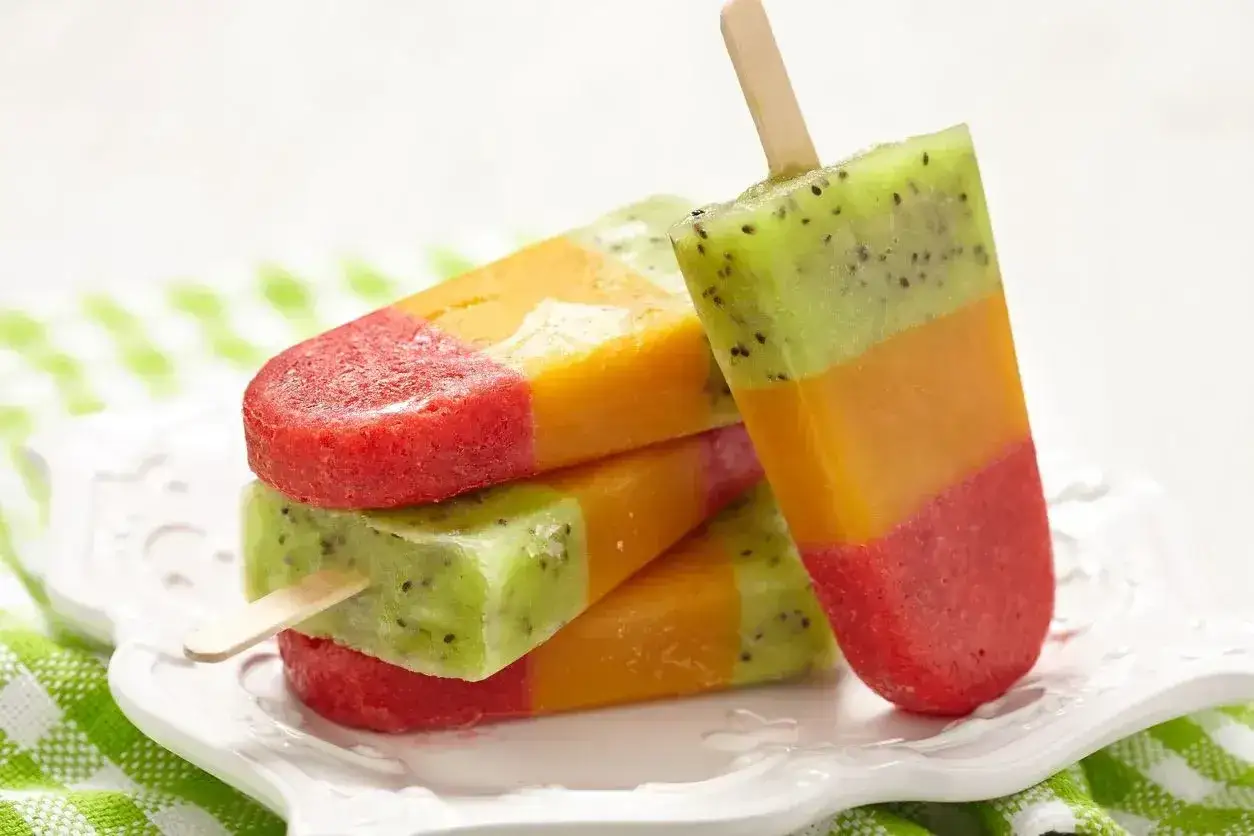 Kolorowe, warstwowe domowe lody na patyku z kiwi, mango i truskawkami. Idealne na upalne dni!